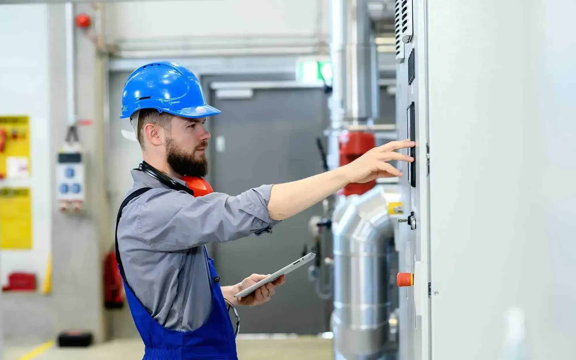 Technician diagnosing an air conditioning system on an emergency call.